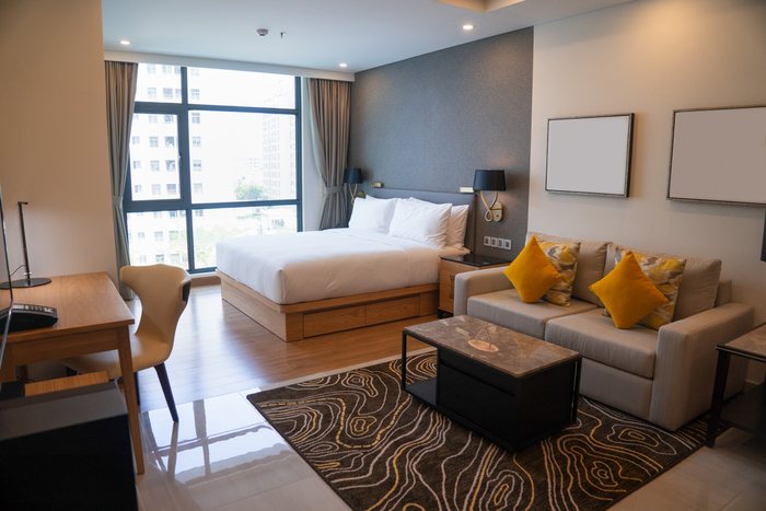 Single room with a desk, sofa and city view